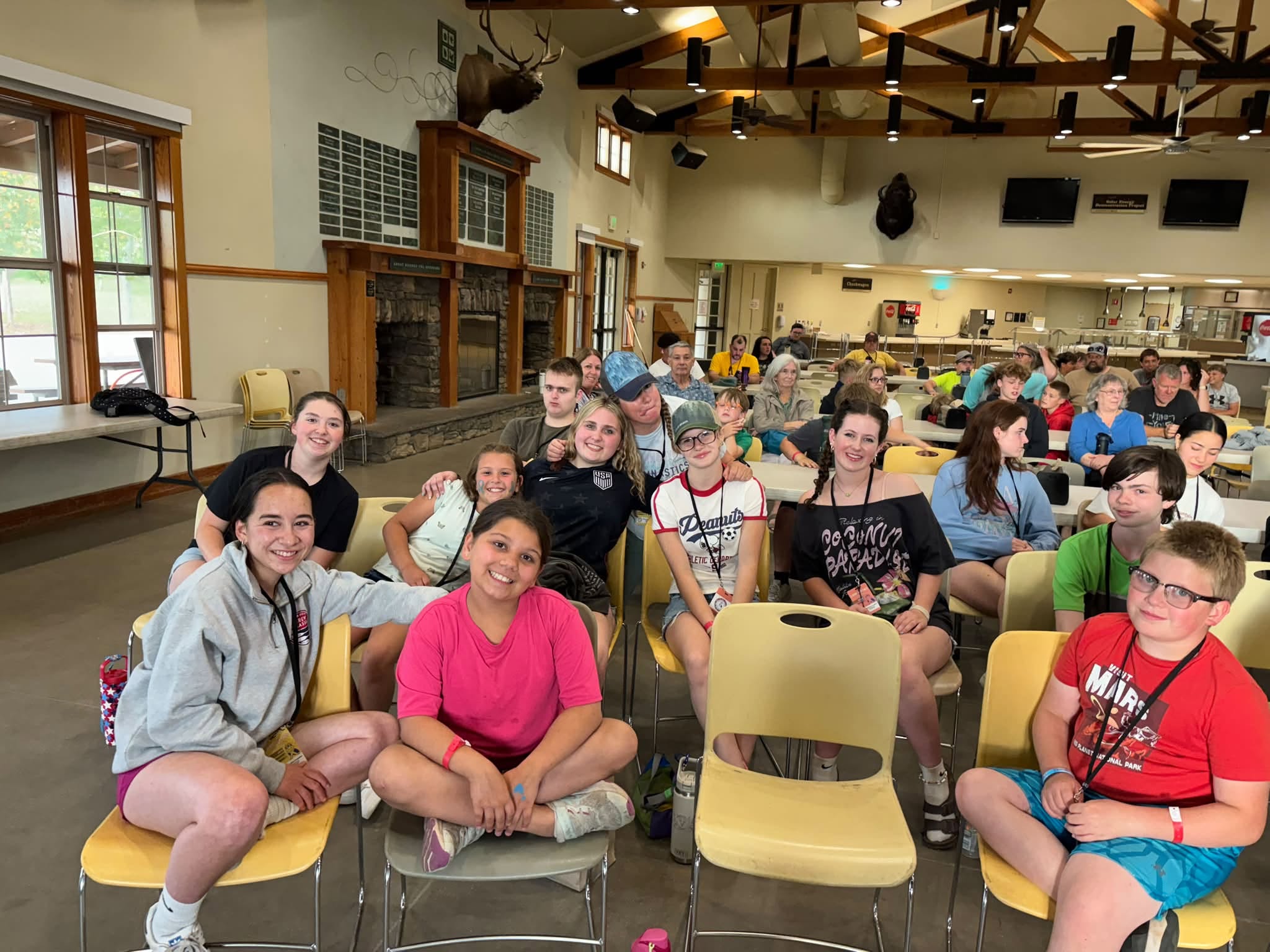 A group of Camp Perthes campers and counselors, boys and girls, smiling together at camp