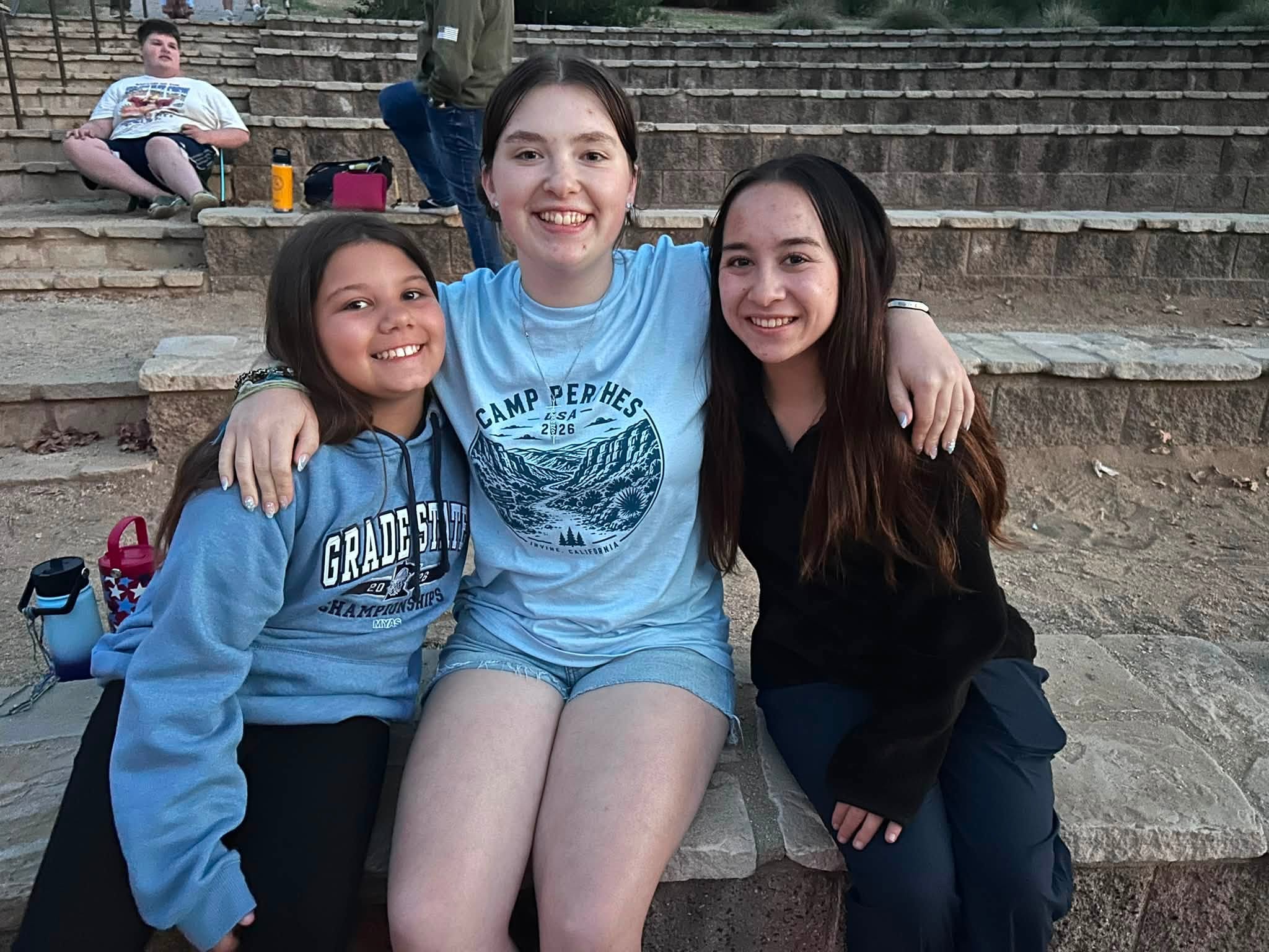 New friends arm in arm at camp