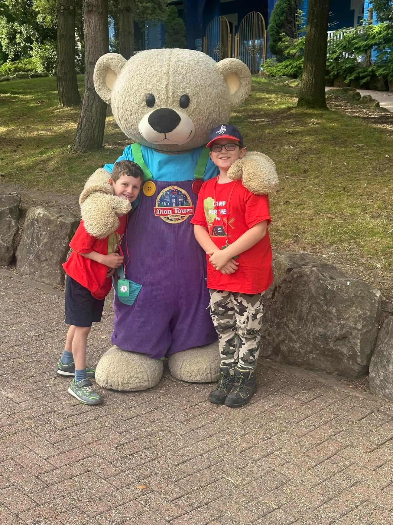 A camper hugging the Camp Perthes mascot bear
